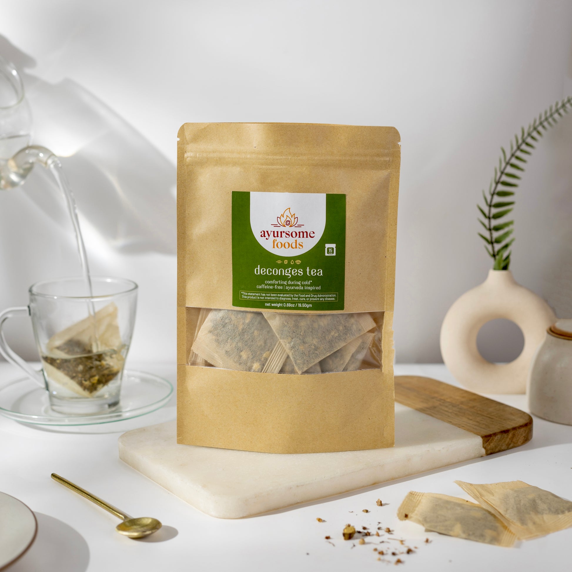 organic tulsi ginger tea blend for cold weather in a tea bag. the tea bags are in a compostable material and the shot on a white background