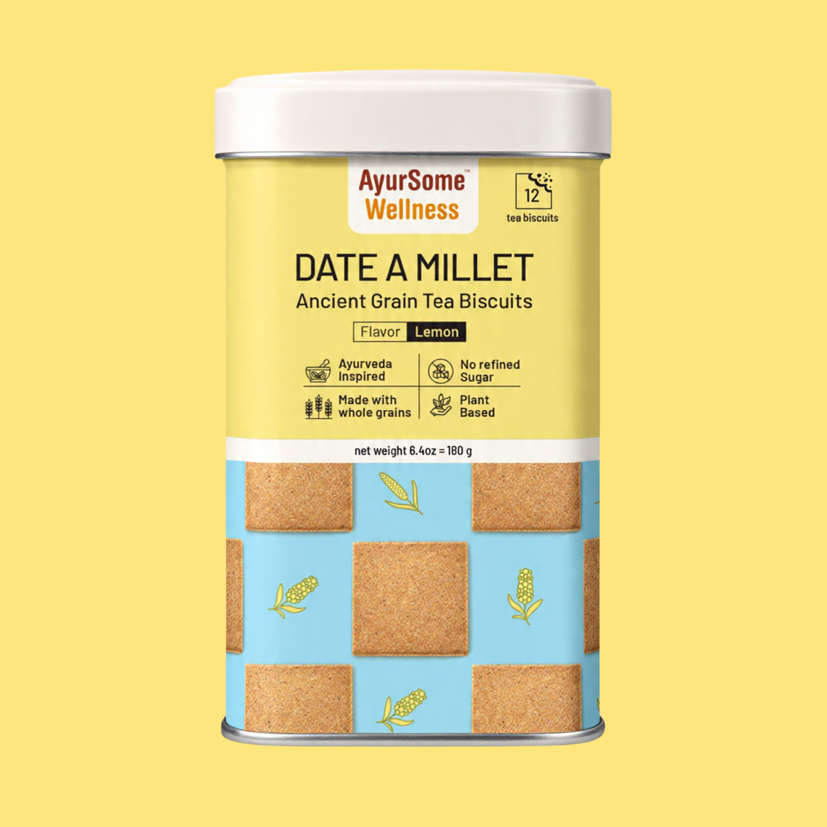A cylindrical metal tin of AyurSome Wellness Date A Millet cookies, featuring a yellow upper label, a light blue lower section with printed millet cookies illustrations, and a white lid. The flavor is Lemon and the cookies have no refined sugar, are made with whole grains and are plant based.